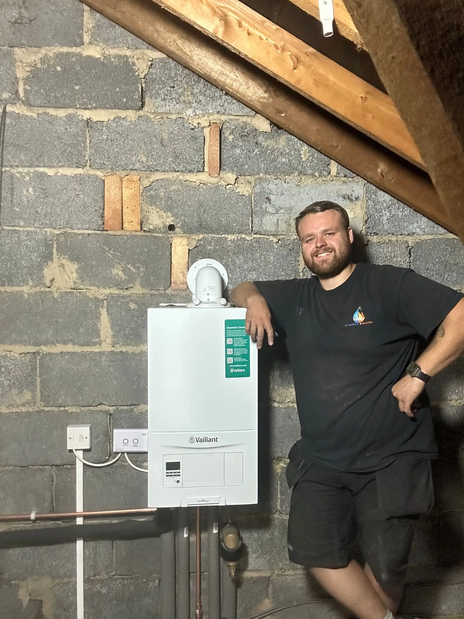 Harry Duggan, owner of H.M.D Plumbing & Heating, beside a new Vaillant boiler